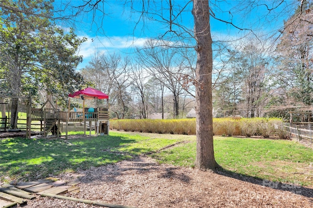 view of yard with a playground and fence