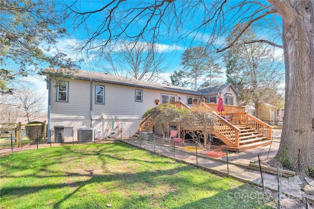 back of property featuring a yard, fence, a deck, cooling unit, and stairs