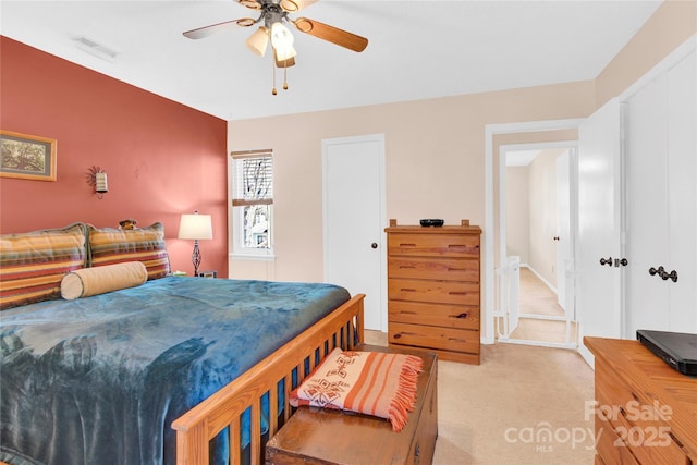 bedroom with light carpet, ceiling fan, and visible vents