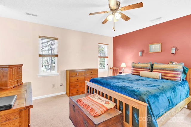 bedroom featuring carpet floors, multiple windows, visible vents, and baseboards