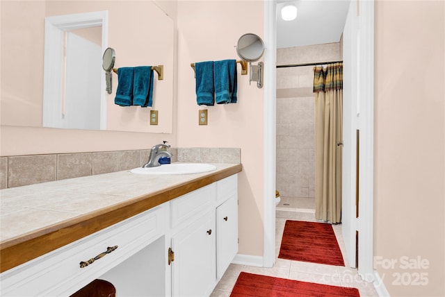 full bath with tile patterned flooring, a shower stall, and vanity