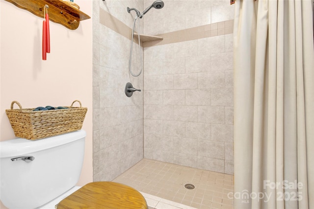 bathroom featuring a stall shower and toilet