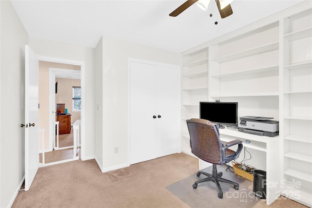 carpeted home office featuring ceiling fan and baseboards