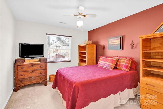 carpeted bedroom featuring ceiling fan, visible vents, and baseboards