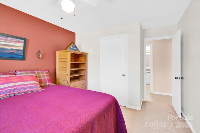 carpeted bedroom featuring ceiling fan and baseboards