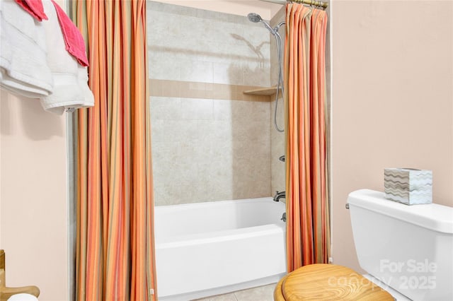 full bathroom featuring tile patterned flooring, toilet, and shower / bath combo with shower curtain