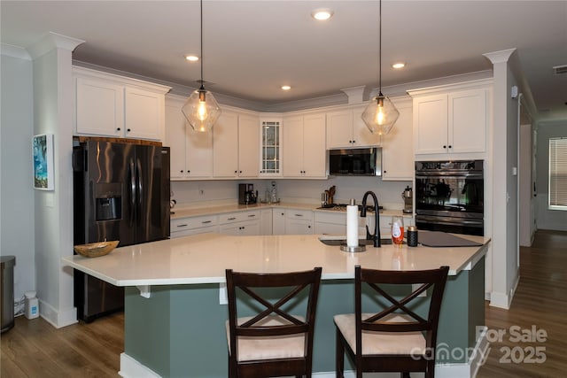 kitchen with black appliances, dark wood-style floors, white cabinetry, and light countertops