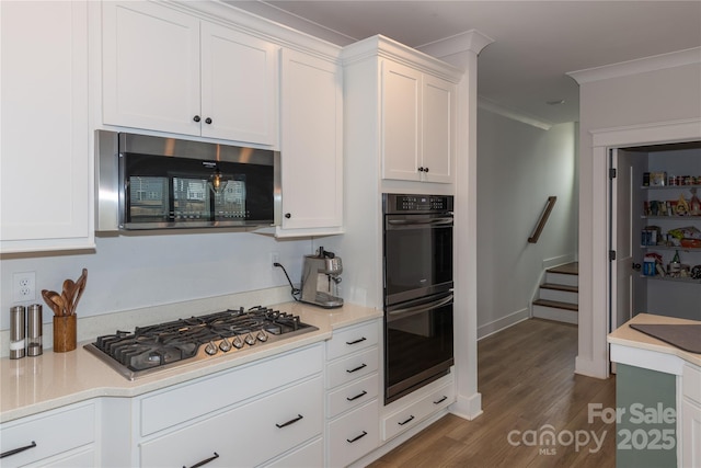 kitchen featuring light countertops, appliances with stainless steel finishes, and white cabinets