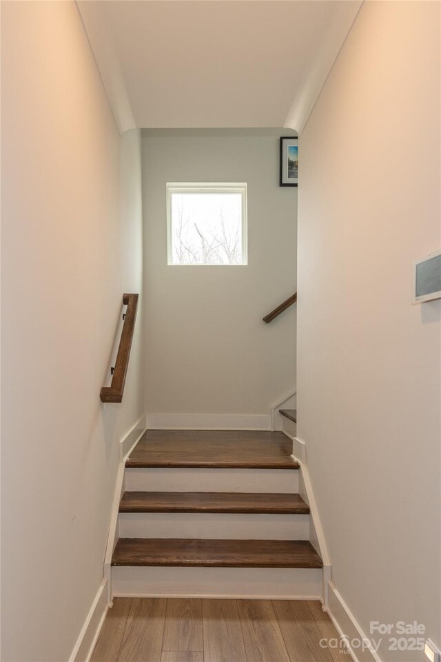 stairs with baseboards and wood finished floors