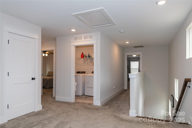 hallway with washing machine and dryer, visible vents, carpet flooring, and recessed lighting