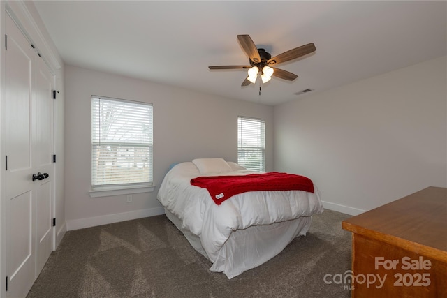 carpeted bedroom featuring baseboards, visible vents, and ceiling fan