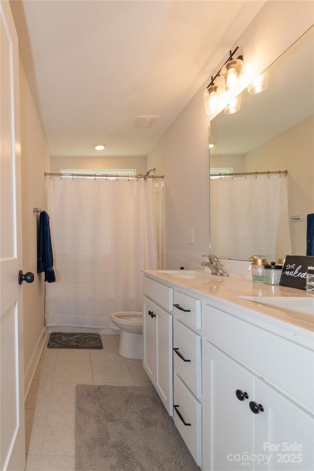 full bathroom with double vanity, visible vents, toilet, a sink, and tile patterned floors