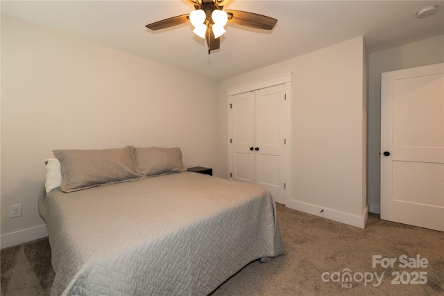 carpeted bedroom featuring a closet, a ceiling fan, and baseboards