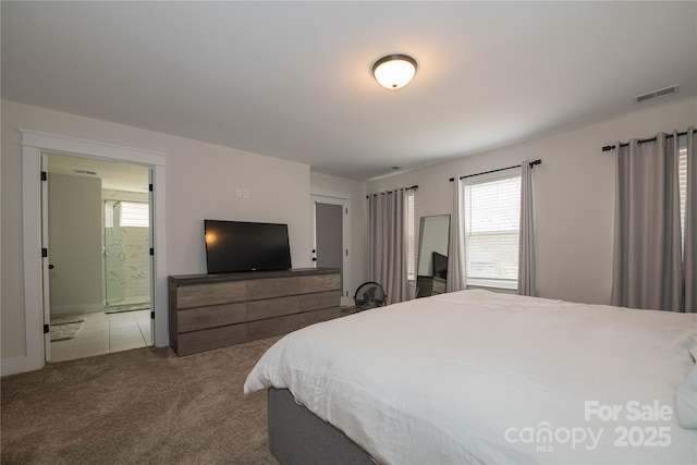 bedroom featuring carpet floors, visible vents, and connected bathroom