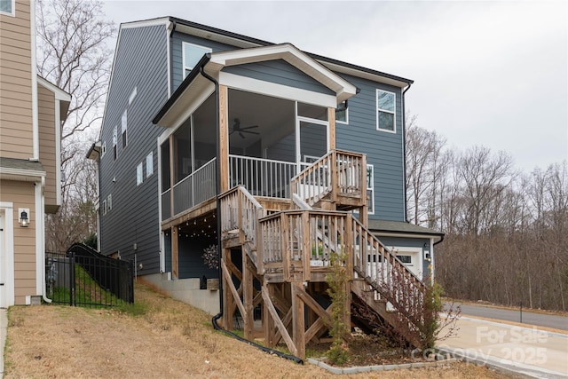 view of front of property featuring stairs, a sunroom, and a ceiling fan