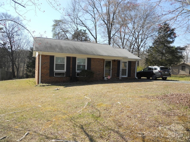 ranch-style home with brick siding and a front yard