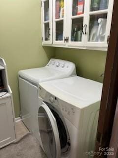 laundry area featuring cabinet space and separate washer and dryer