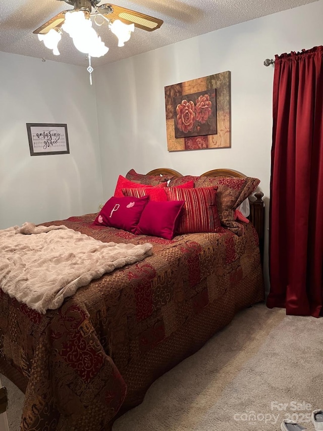 carpeted bedroom with a textured ceiling and ceiling fan