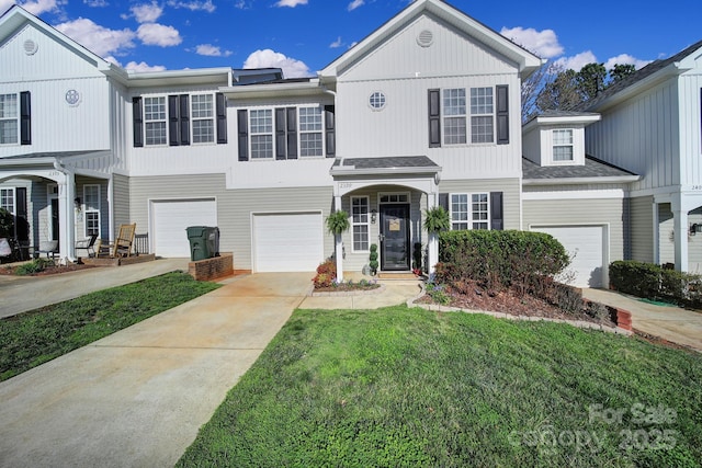 view of front of house with concrete driveway, a garage, and a front yard