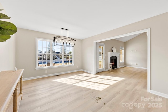 unfurnished dining area featuring visible vents, baseboards, and light wood finished floors