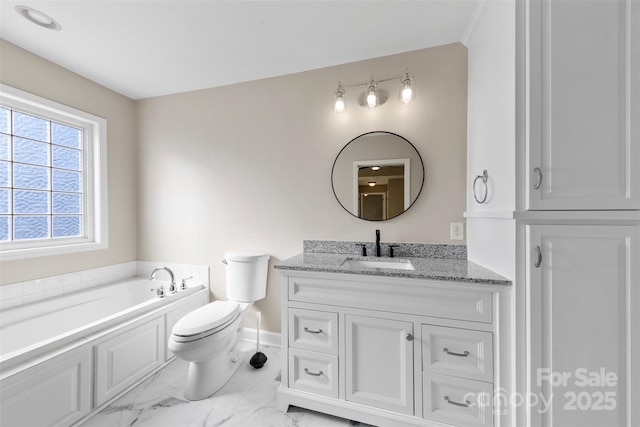 bathroom with vanity, baseboards, a garden tub, toilet, and marble finish floor