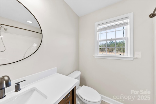 bathroom featuring toilet and vanity