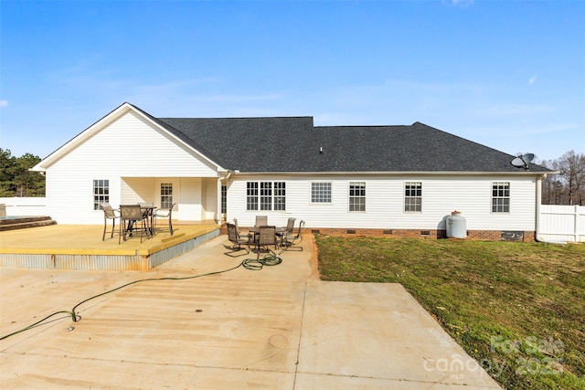 rear view of property with outdoor dining space, fence, roof with shingles, a wooden deck, and crawl space