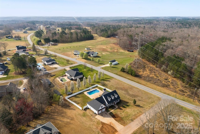 birds eye view of property with a rural view