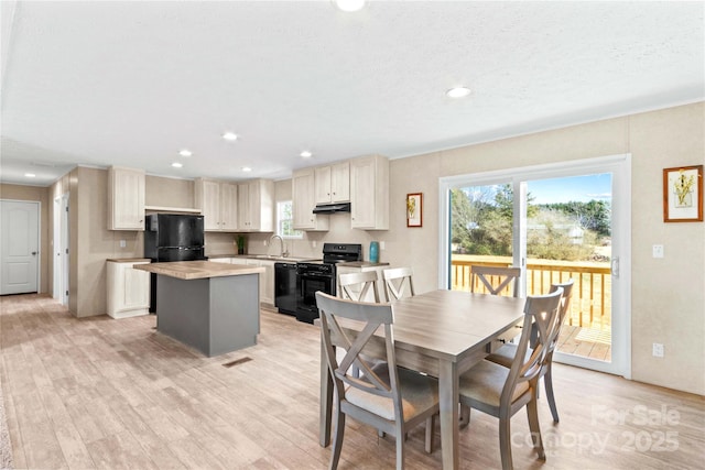 dining space featuring plenty of natural light, light wood-style flooring, and recessed lighting