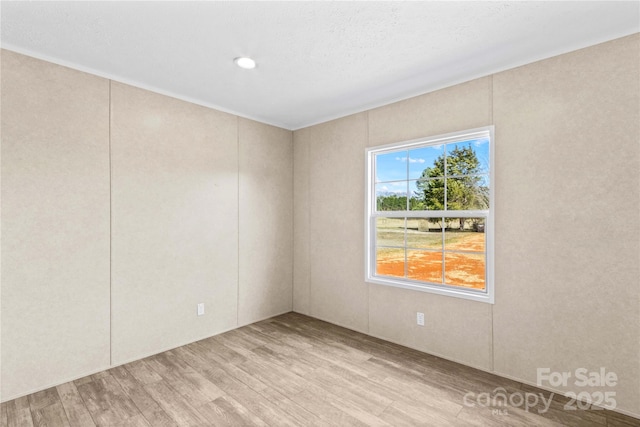 unfurnished room featuring light wood-style floors