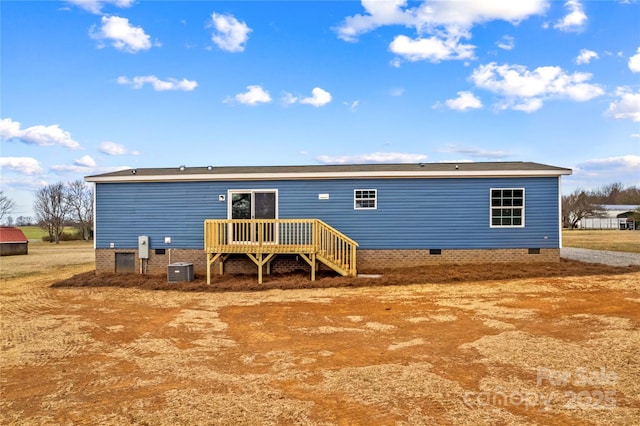 rear view of property with central AC unit and crawl space