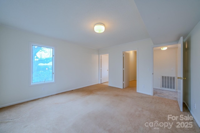 unfurnished bedroom featuring visible vents, baseboards, and carpet