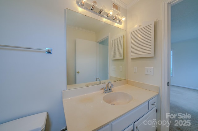 bathroom with vanity, crown molding, toilet, and visible vents