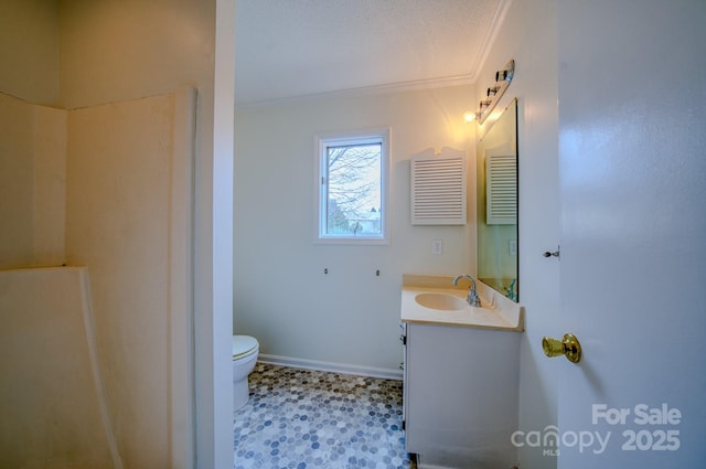 bathroom with toilet, vanity, baseboards, and ornamental molding