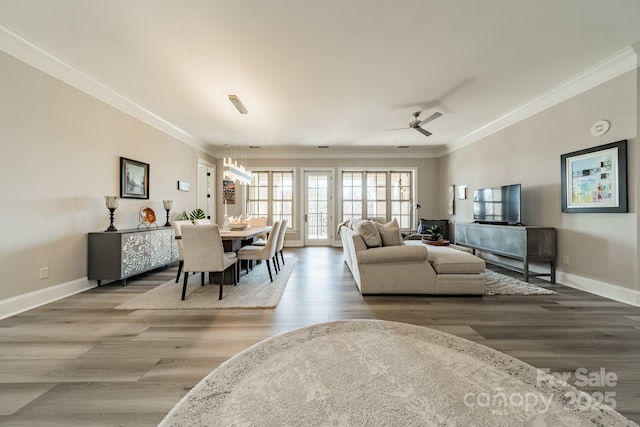 dining space with crown molding, wood finished floors, and baseboards