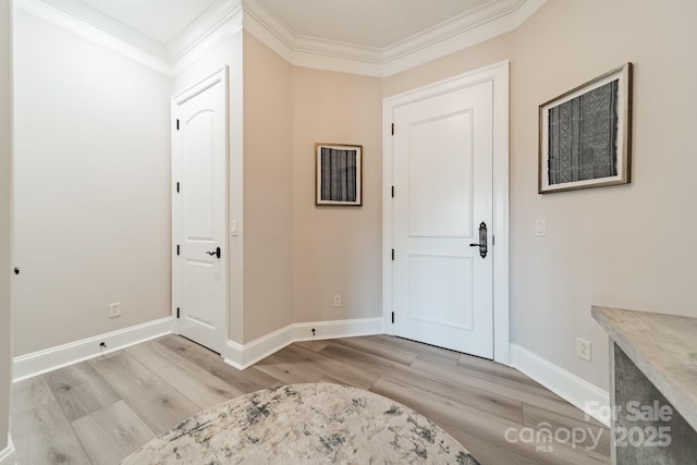 entrance foyer featuring light wood-type flooring, baseboards, and ornamental molding