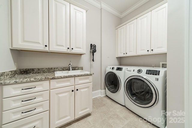 clothes washing area featuring baseboards, cabinet space, ornamental molding, a sink, and washing machine and dryer