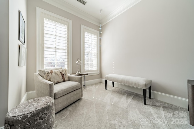 living area featuring carpet, baseboards, and ornamental molding