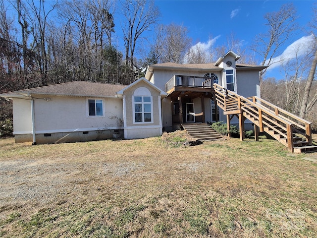 view of front of home with stairway, crawl space, a shingled roof, and a front lawn