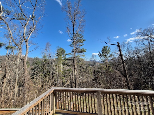 wooden deck featuring a forest view