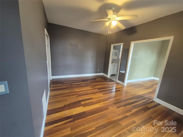 unfurnished room with ceiling fan, wood finished floors, and baseboards