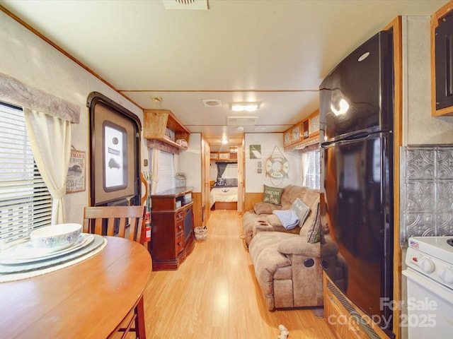 living room featuring visible vents and wood finished floors