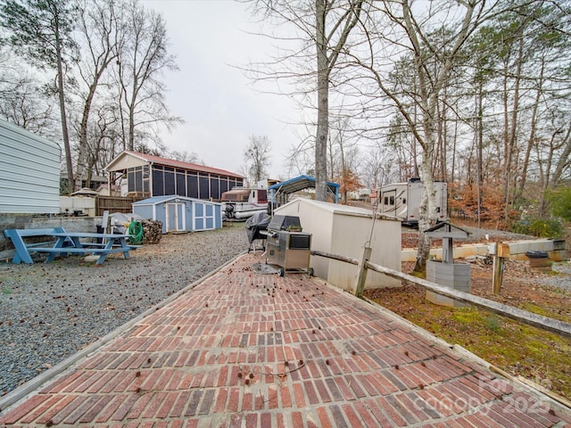 view of patio / terrace featuring a storage unit and an outdoor structure