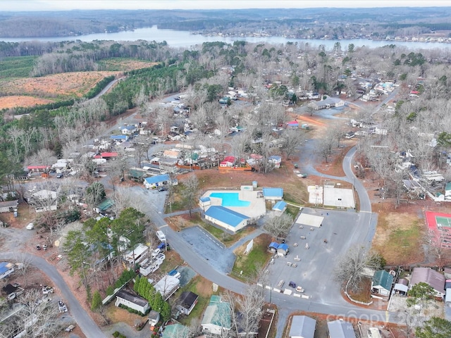 drone / aerial view with a water view and a view of trees