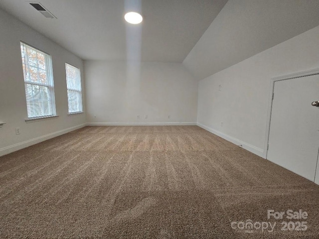 bonus room with carpet floors, visible vents, vaulted ceiling, and baseboards