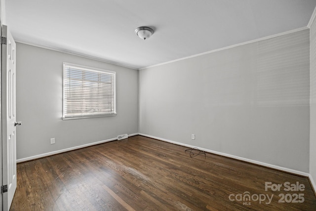 unfurnished room with baseboards, visible vents, dark wood-type flooring, and ornamental molding