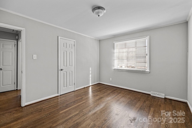 unfurnished bedroom with a closet, visible vents, ornamental molding, wood finished floors, and baseboards