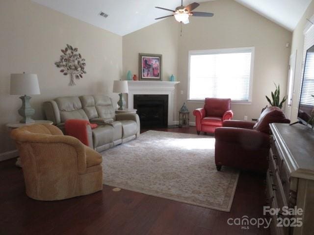 living room featuring visible vents, wood finished floors, a fireplace, lofted ceiling, and ceiling fan