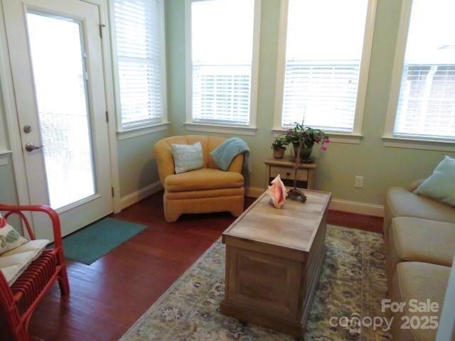 living area featuring wood finished floors and baseboards