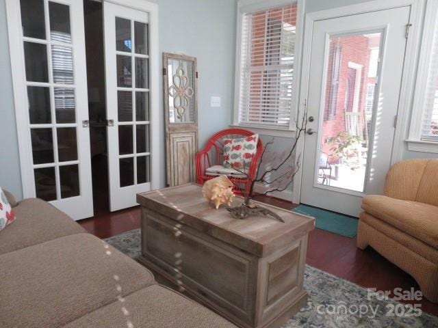 sitting room featuring wood finished floors and french doors